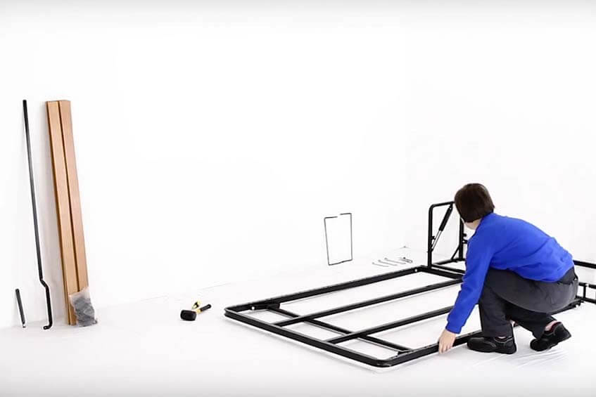 Person installing a Wall Bed King frame